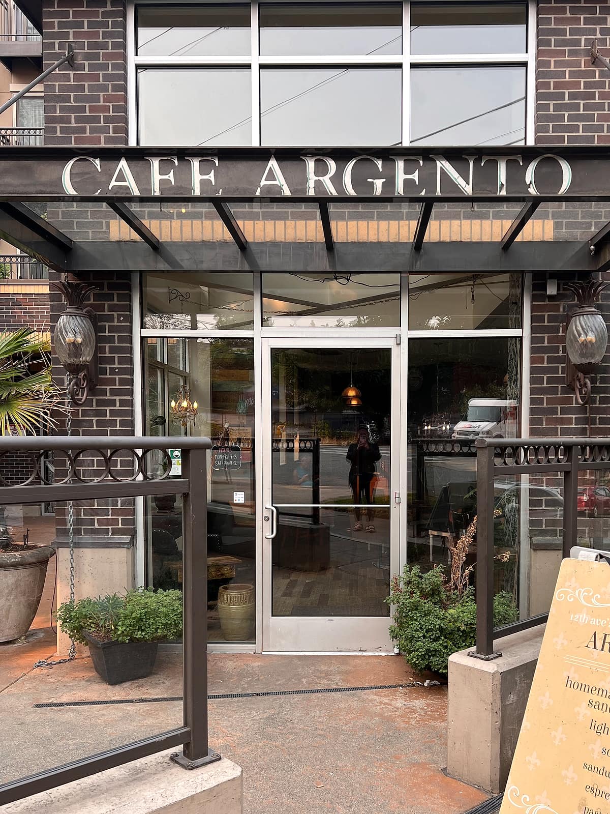 The Cafe Argento storefront on East Olive Street, steel letters across the awning and the sandwich board on the sidewalk.